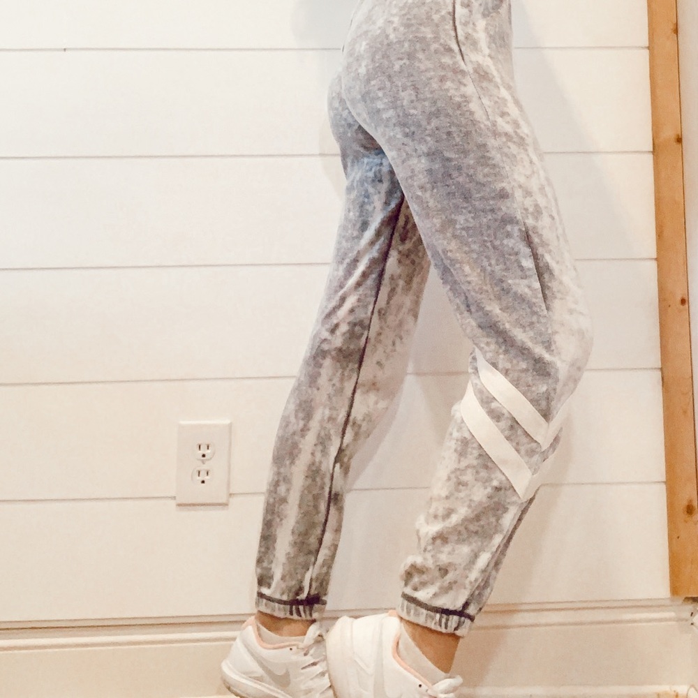 grey sweatpants with white athletic stripes